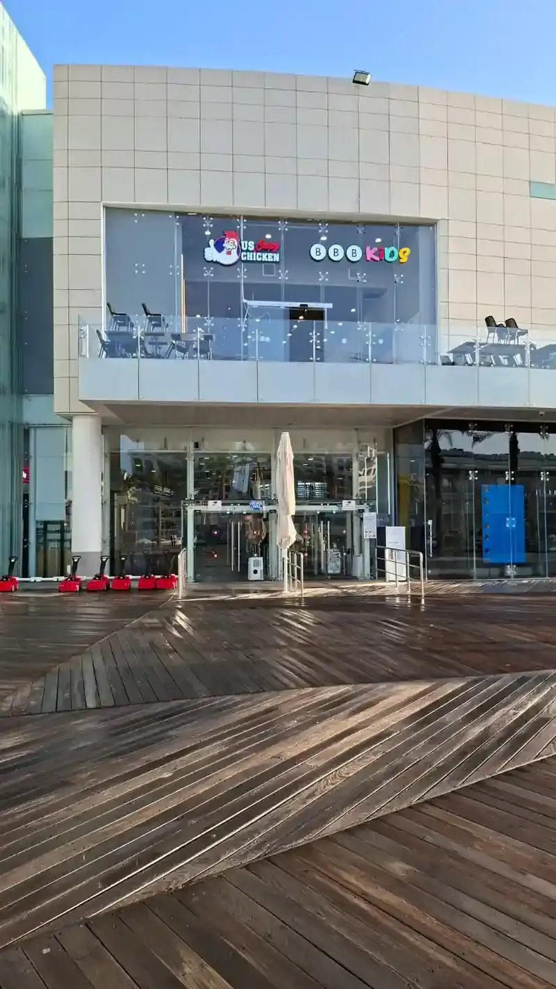 Building exterior with illuminated channel letter signs for multiple businesses